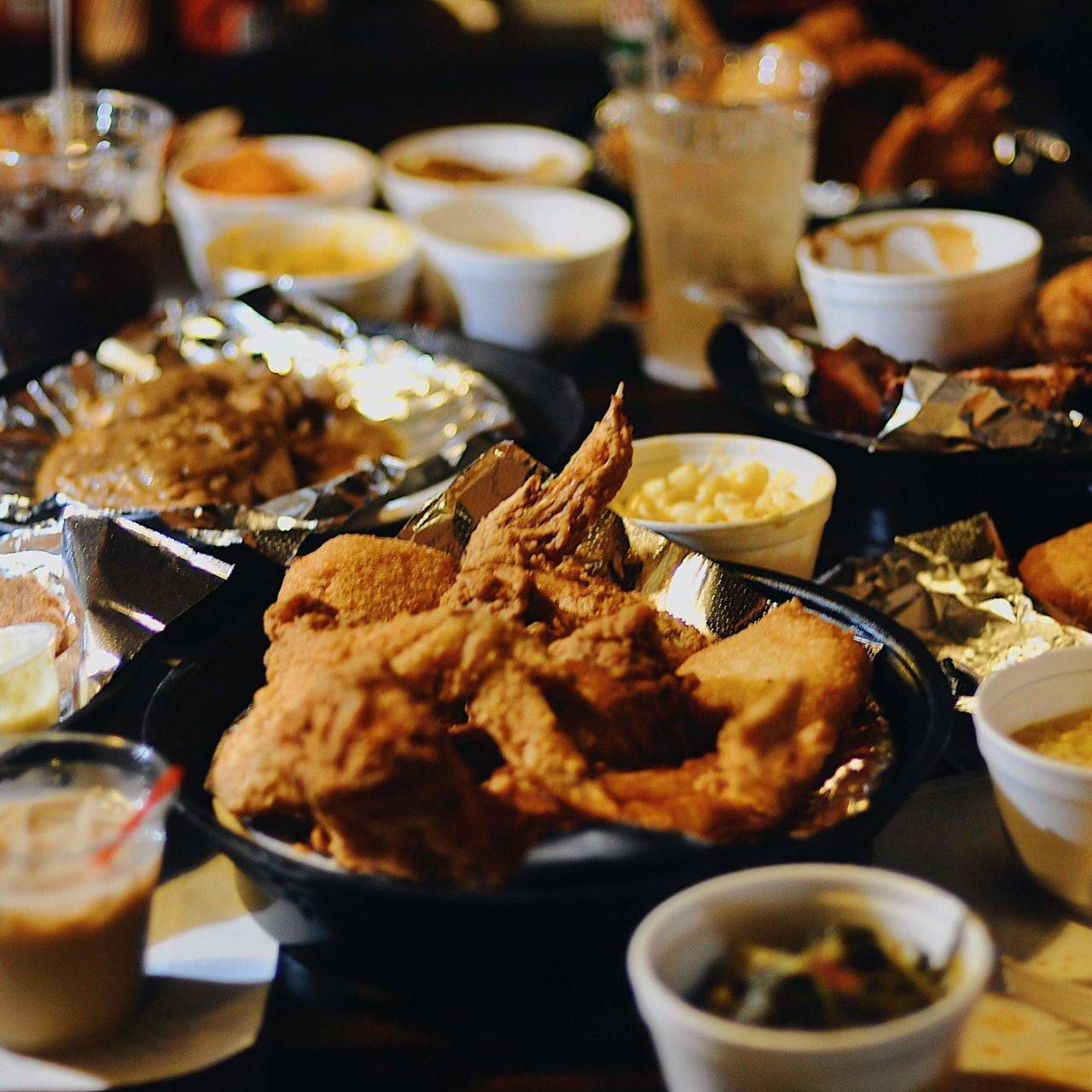 a table covered with fried foods and a wide variety of sides at Shirley Mae's Café, a soul food restaurant in Louisville, KY